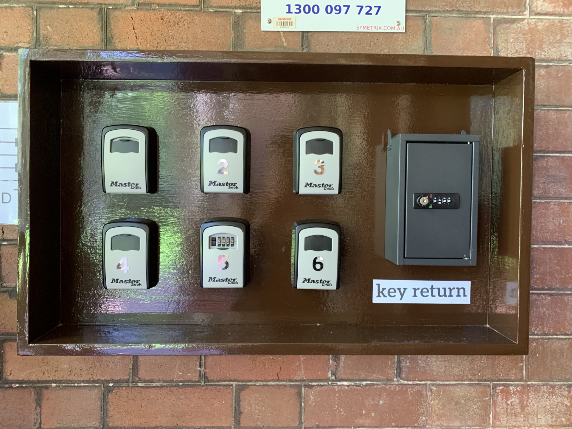 Numbered Falcon Lodge lockboxes with the separate key-return box on the right
